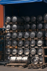 Plakat Metal barrel. Keg with beer. A large number. Stock. Logistics and alcohol concept. Wooden pallets.