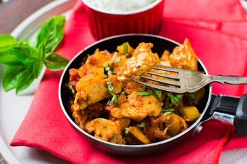 Chicken, tomato and zucchini sauce served with rice.
