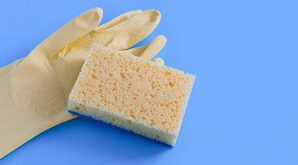 yellow gloves and sponge on a blue background. Banner. Cleaning.
