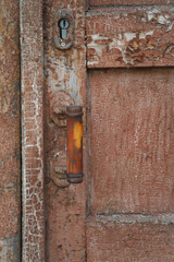 Close-up texture of old dark wooden entrance. Background of rough distressed door leafs. Shabby scratched natural timber.