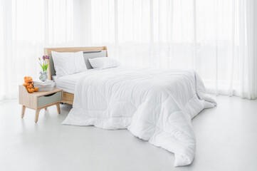 Interior white bedroom with white curtains and white pillows on wooden bed classic for relaxing and sleeping.