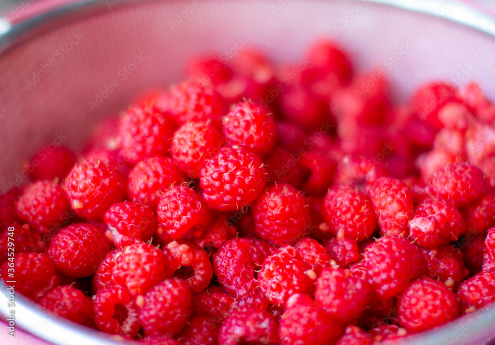 Poster Red raspberry berry in a bucket. The view from the top