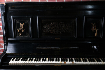 Naklejka na ściany i meble old black piano with a copper yellow candlestick