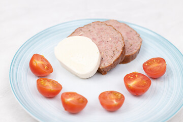 Sliced Meatloaf served with cheese and cherry tomatoes