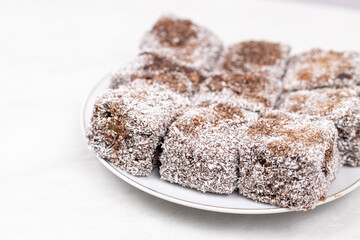 Square Chocolate cookies with coconut served on the plate
