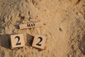 May 22, Number cube with Sand pile for a background.