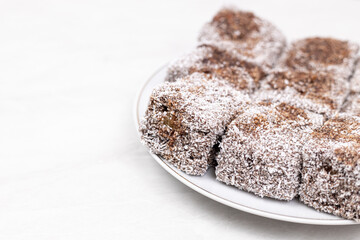 Square Chocolate cookies with coconut served on the plate