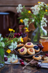 Obraz na płótnie Canvas Thumbprint almond cookies with jam