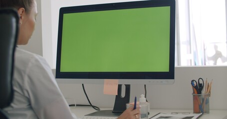 physician work on computer with green mockup screen