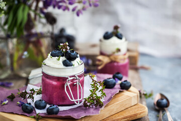 Blueberry Panna Cotta decorated with cream and fresh berries