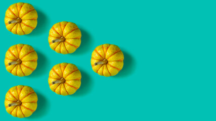 Pattern with pumpkins on a green background. Copy space
