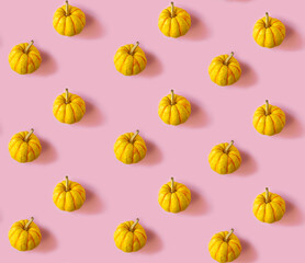 Seamless pattern with pumpkins on a pink background