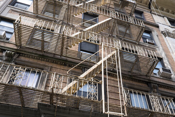 Typical industrial building in New York with fire escape ladders in New York, USA