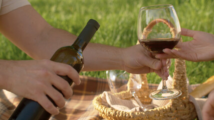 Male hand pouring wine into a wineglass