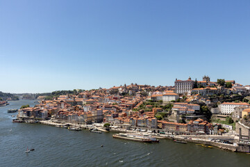 Fototapeta na wymiar Colorful houses of Porto Ribeira, traditional facades, old multi-colored houses with red roof tiles on the embankment in the city of Porto, Portugal. Unesco World Heritage site.
