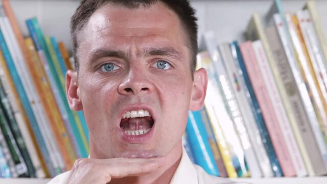 A man shows an articulation exercise. Bradilalia treatment. Jaw movement with a click of the tongue. Linguistic muscle training in pronunciation and learning a new language.