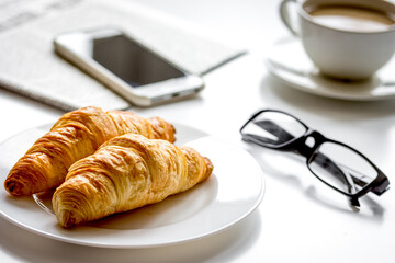 Business lunch with croissant on white table top view