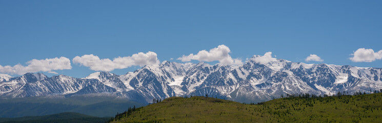Mountain range with melting snow. View from the valley.