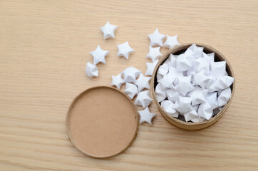 Obraz na płótnie Canvas white lucky stars and brown paper jar