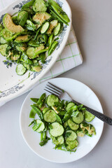 healthy, summer salad of avocado, cucumber, sugar pea pods