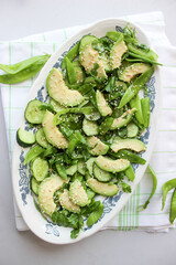 healthy, summer salad of avocado, cucumber, sugar pea pods