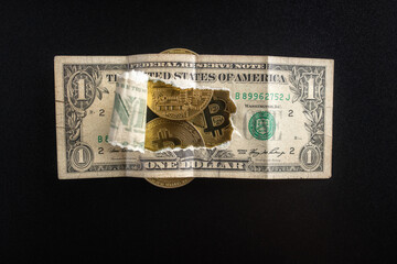 Close-up: a torn dollar bill through which Bitcoin coins are visible. Finance and business