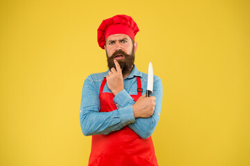 Fototapeta na wymiar Bring food party. professional man cooking. restaurant cuisine and culinary. catering company ad. welcome to our cafe. time to eat. amzed bearded chef hold knife. brutal male cook in hat and apron