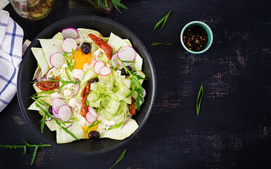 Chilaquiles (in Mexican cooking) a dish of fried tortilla strips  with a eggs and cheese. Mexican food. Mexican breakfast. Top view, flat lay, copy space
