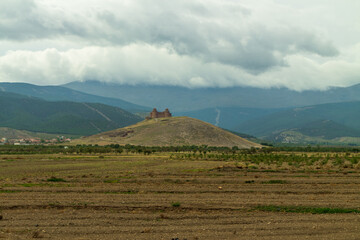 empty fields and castle on the hill