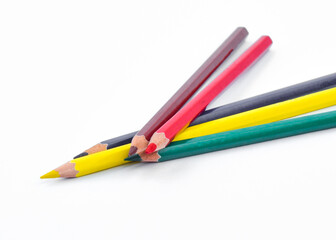 Five different color wood pencil crayon placed two on top of three crayons