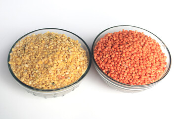 Pile of uncooked red lentils and pigeon pea. Mung beans and red lentils in two bowls isolated on white background.