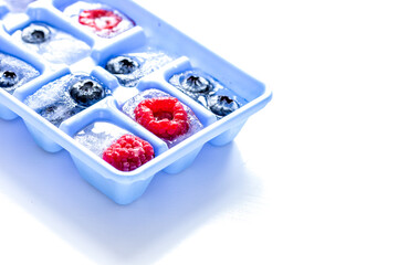 Ice tray with frozen berries on white background mockup
