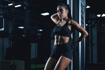 Fototapeta na wymiar Fitnesswoman posing near gym machine.