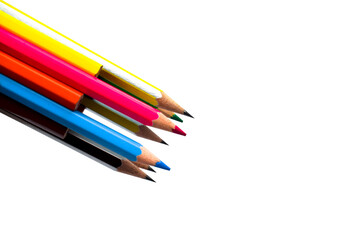 A pile of different colored wood pencil crayon placed on a white background