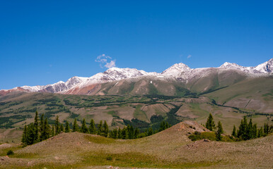 Mountain range with melting snow. View from the valley