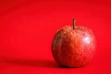 red apple on a red background