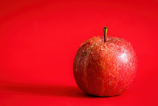 red apple on a red background