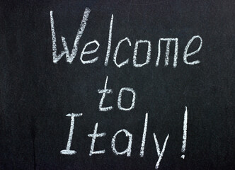 The inscription on the dark banner "Welcome to Italy!". Welcome for the guests of the country