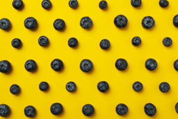 Flat lay with fresh blueberry on yellow background