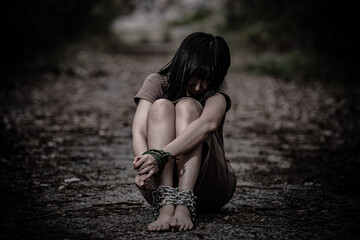 Asian hostage woman Bound with rope at night scene,The thieves kidnapped for ransom,thailand people