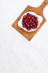 Cherries in the bowl with copy space above table