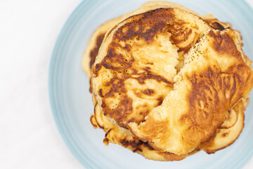 Top view of stacked pancakes served on the plate