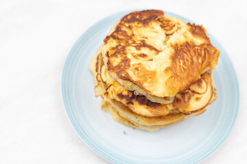 Top view of stacked pancakes served on the plate