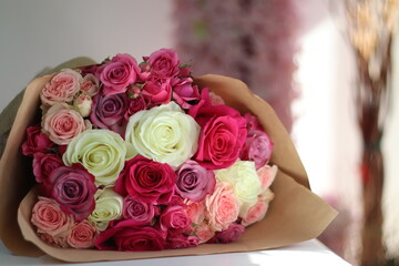a beautiful bouquet with pink and white blooming roses for a bride during her wedding