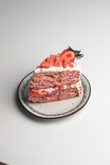 Strawberry cake dessert with fresh cut strawberries on the top for garnish. two layer pink colored cake with white frosting. naked cake style - 364548373