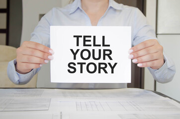 woman holds a tablet with text. text tell your story