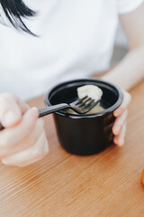 Street food in a black disposable plastic bowl. Russian and Ukrainian dish - dumplings in the broth