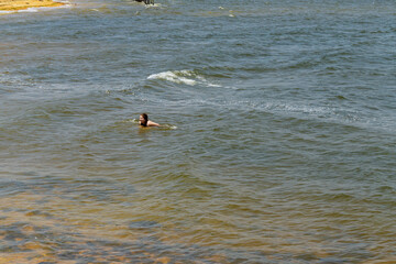 Girl swimming in the water at the ocean. Soft focus.