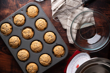 chocolate chip muffin on dark wooden board