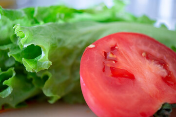 Lettuce leaves and tomato cut in half